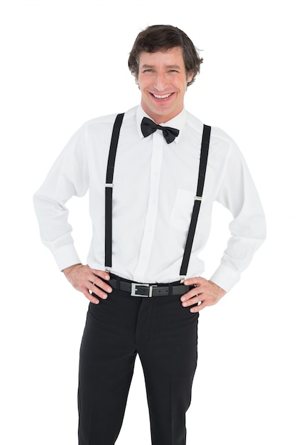 Smiling groom wearing suspenders