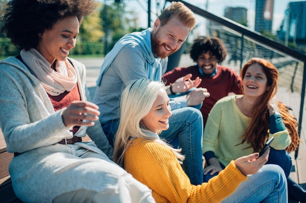 Smiling group of diverse businesspeople working together around a meeting table in an office complex lobby