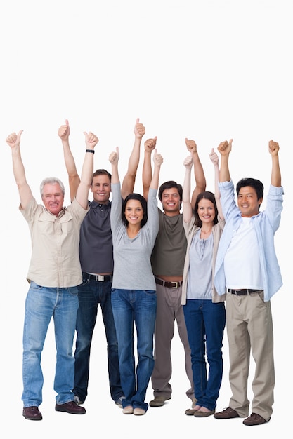 Photo smiling group of friends giving thumbs up