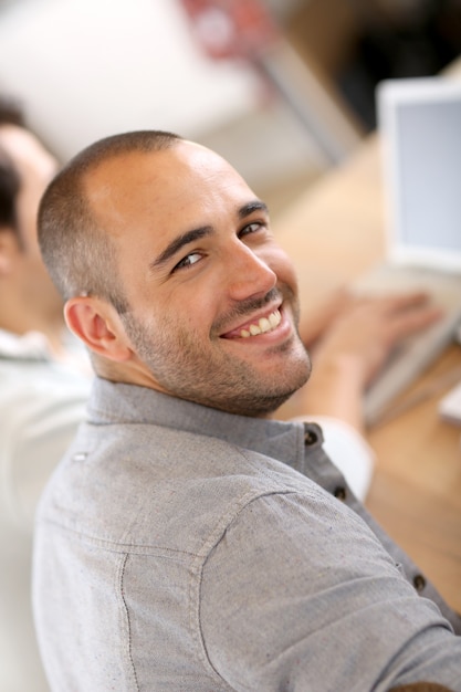 Smiling guy in business training attending meeting