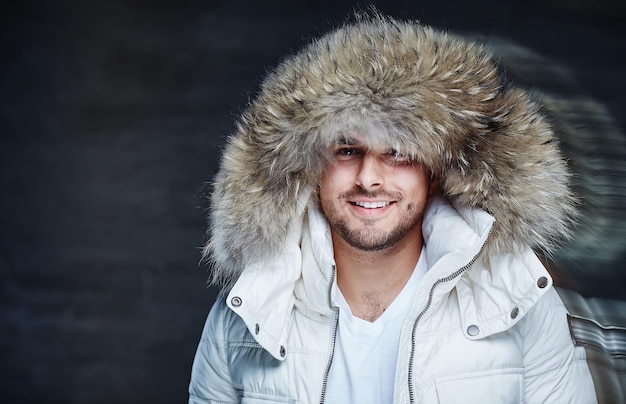 Smiling guy in a white coat and fur hood.