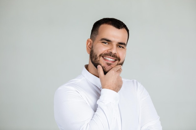 Smiling handsome bearded man looking at camera