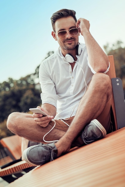 Smiling handsome guy listening to music