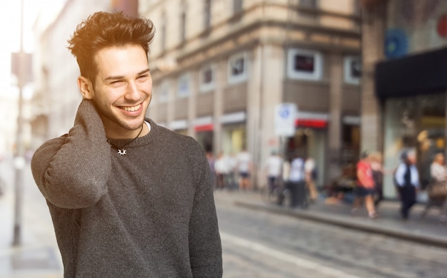 Smiling handsome man walking in the city