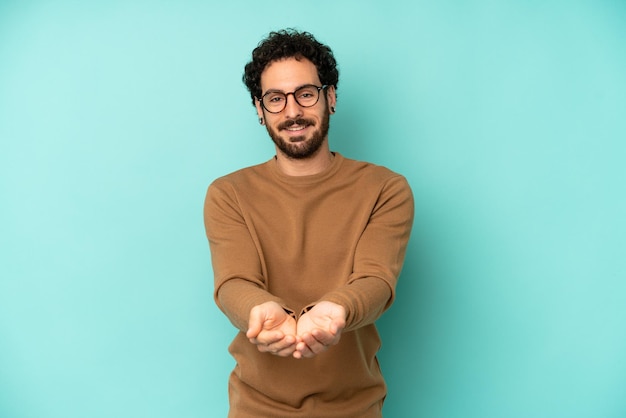 Smiling happily with friendly confident positive look offering and showing an object or concept