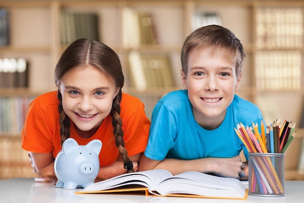 Smiling Happy children sitting by the table during lesson