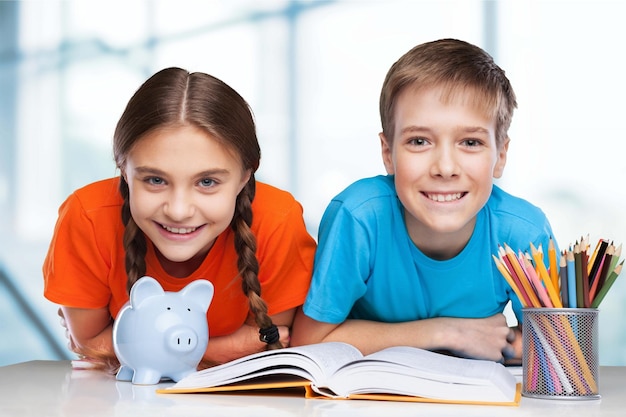 Smiling Happy children sitting by the table during lesson