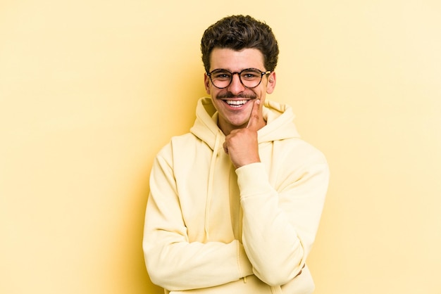 Smiling happy and confident touching chin with hand