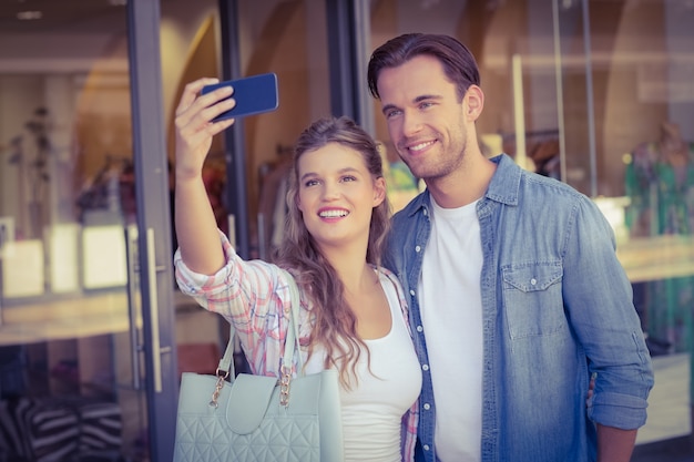 A smiling happy couple taking selfies