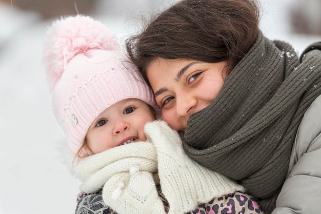 Smiling happy girl and child in winter