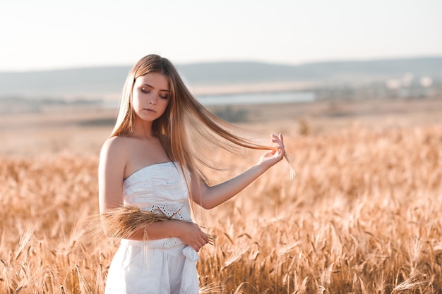 Smiling happy girl in rye meadow outdoors