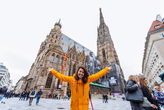 Smiling happy woman portrait in front of vienna cathedral church