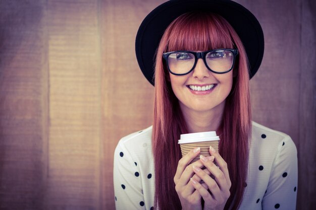 Smiling hipster woman drinking coffee