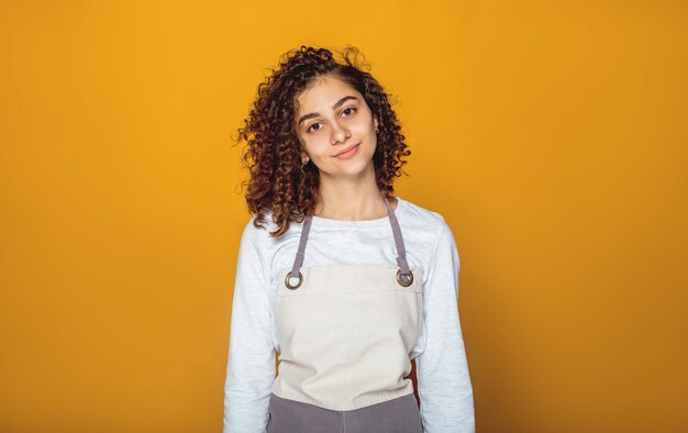 Smiling Indian girl in an apron. 