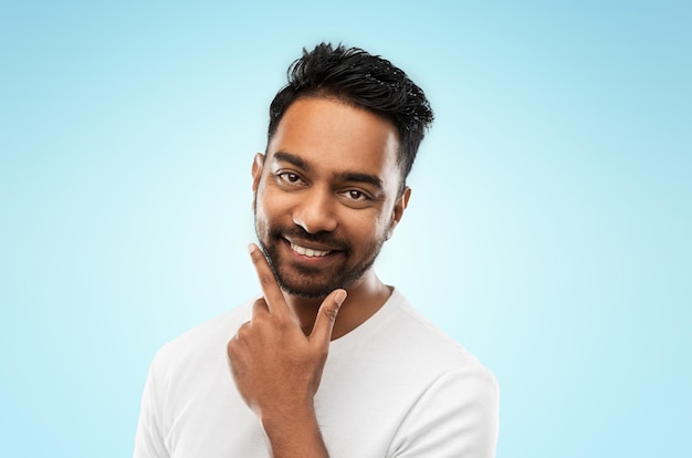 smiling indian man touching his beard