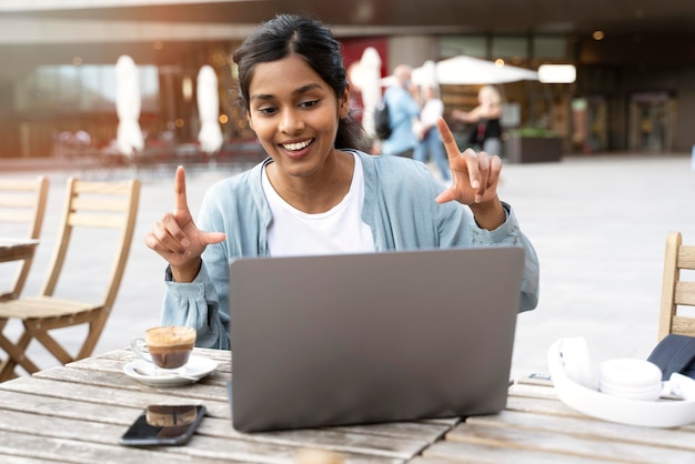 Photo smiling indian woman freelancer using laptop computer communication online, having video call