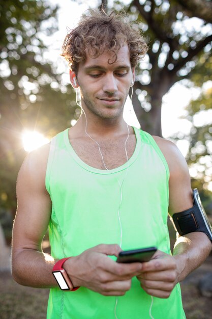 Smiling jogger listening to music