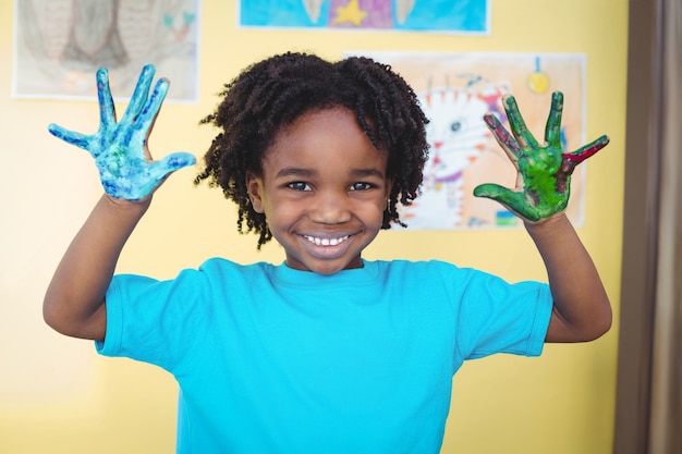 Smiling kid holding up his hands