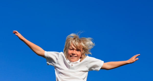 Smiling kid Jumping in the air