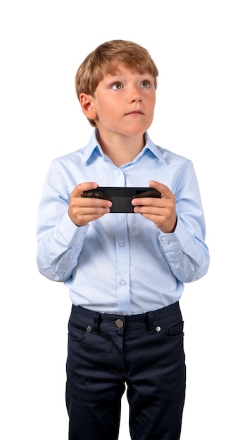Smiling kid playing with phone in hands isolated over white bac