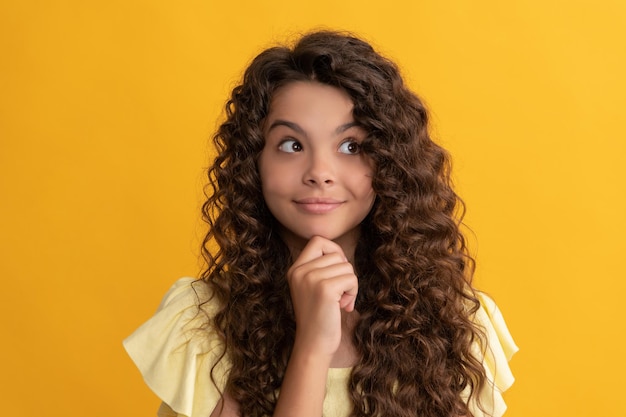 Smiling kid with long curly hair and perfect skin, beauty