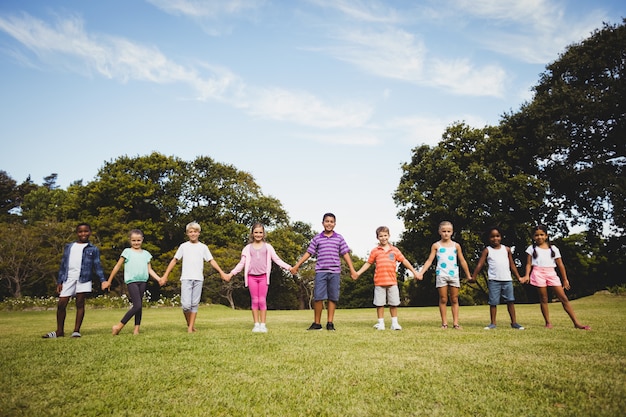 Smiling kids posing together during a sunny day