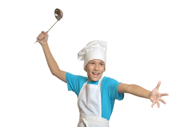 Smiling kitchen boy holding ladle on a white background