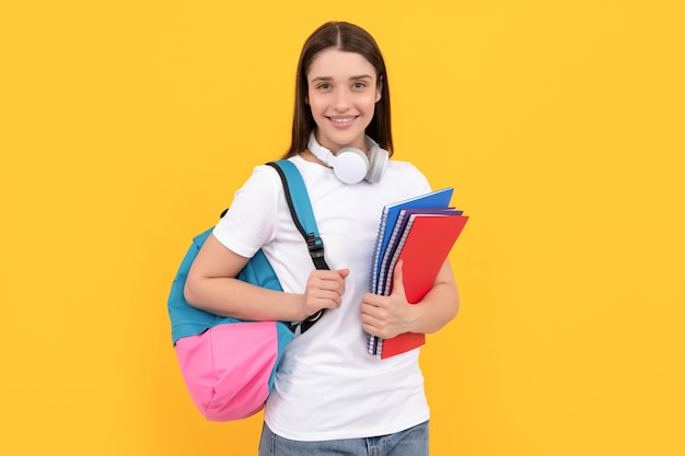 Smiling lady in headphones hold copybook carry backpack knowledge