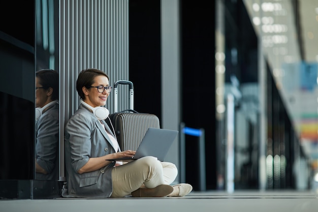 Smiling lady working in airport lobby