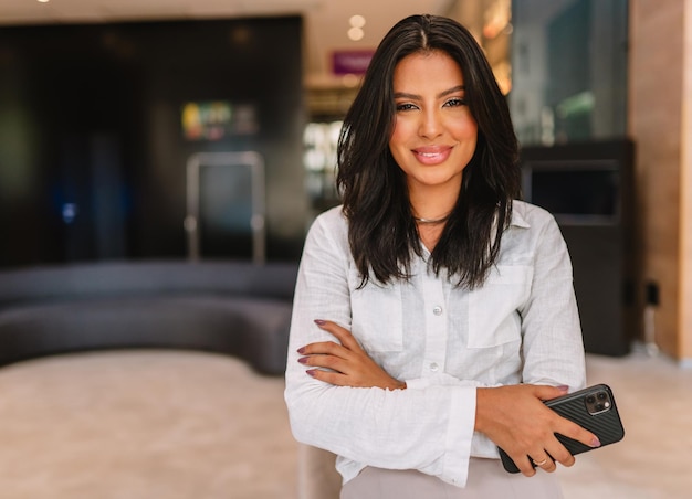 Smiling Latin businesswoman at hotel lobby