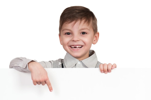 Smiling little boy holding empty white board