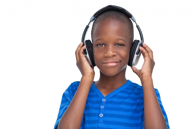 Smiling little boy listening to music