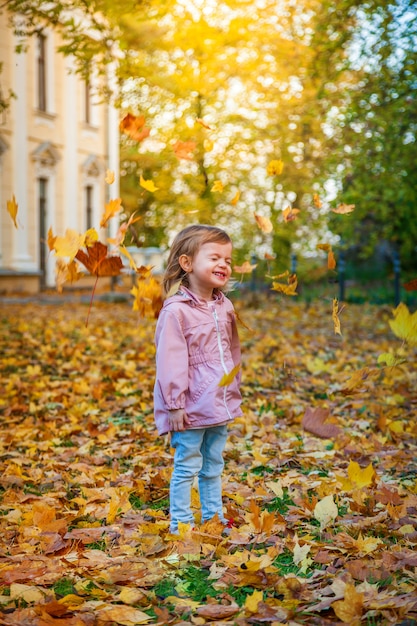 Smiling little girl in the autumn park