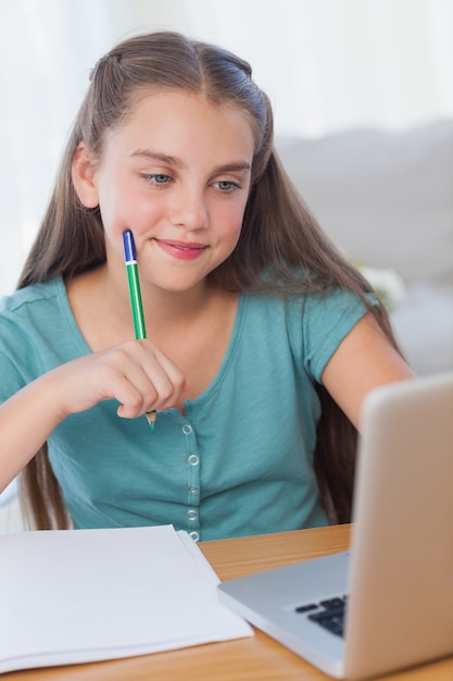 Smiling little girl doing her homework