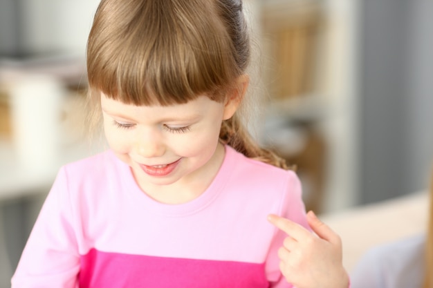 Smiling little girl doing something interesting while playing