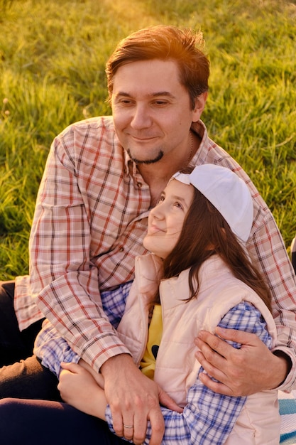 Smiling little girl hugging her father outside