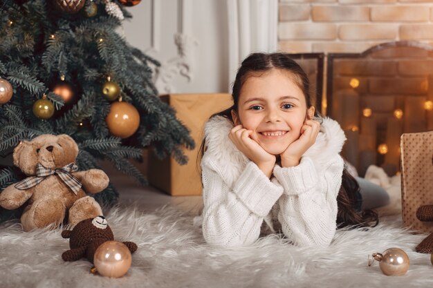 Smiling little girl near Christmas tree