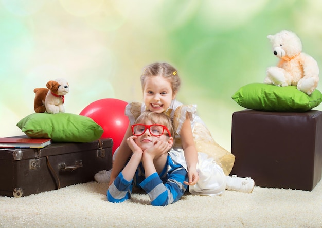 Smiling little girl sitting on the brother's back