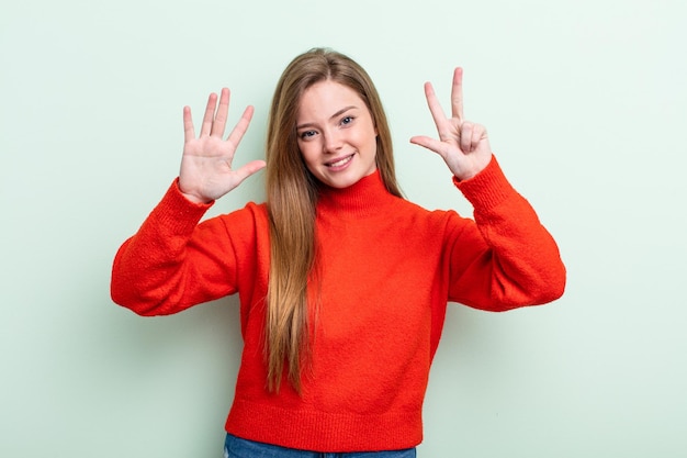 Smiling and looking friendly showing number eight or eighth with hand forward counting down