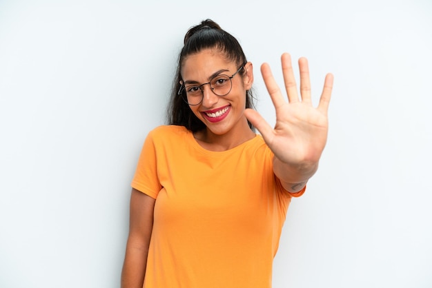 Smiling and looking friendly showing number five or fifth with hand forward counting down