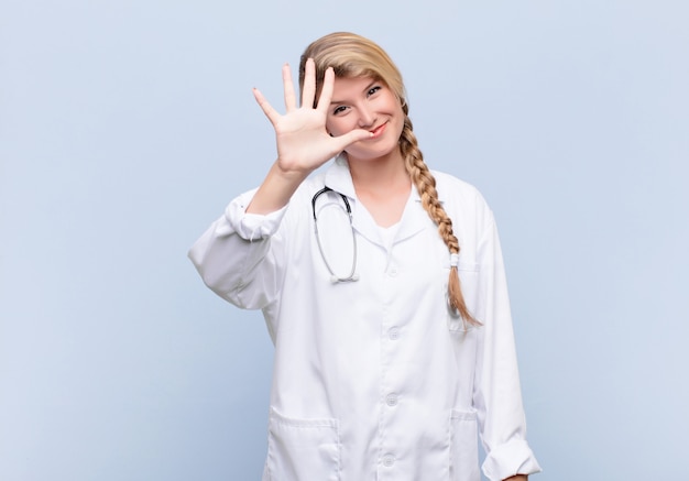 smiling and looking friendly, showing number five or fifth with hand forward, counting down