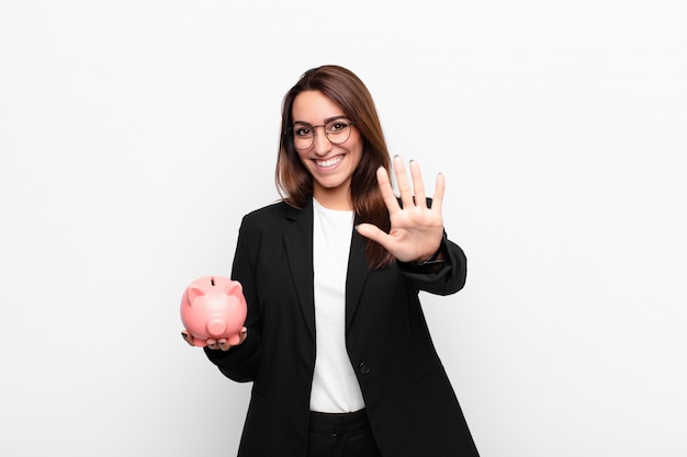 smiling and looking friendly, showing number five or fifth with hand forward, counting down