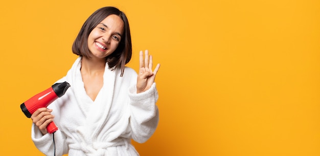 smiling and looking friendly, showing number four or fourth with hand forward, counting down