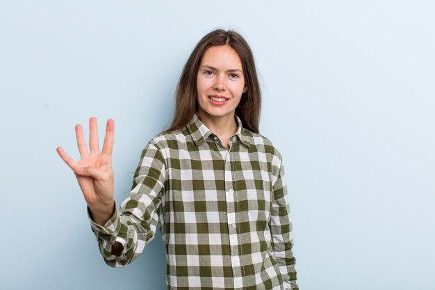 Smiling and looking friendly showing number four or fourth with hand forward counting down