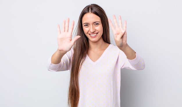 Smiling and looking friendly showing number nine or ninth with hand forward counting down