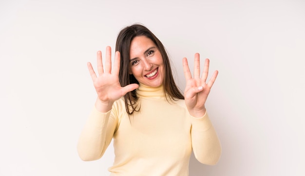 Smiling and looking friendly showing number nine or ninth with hand forward counting down