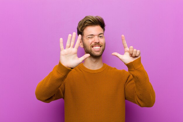 smiling and looking friendly, showing number seven or seventh with hand forward, counting down