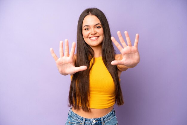 Smiling and looking friendly showing number ten or tenth with hand forward counting down