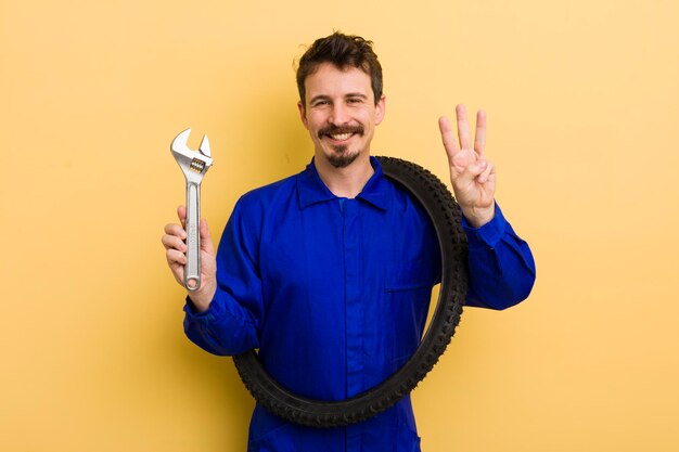 Smiling and looking friendly showing number three bike repairman concept