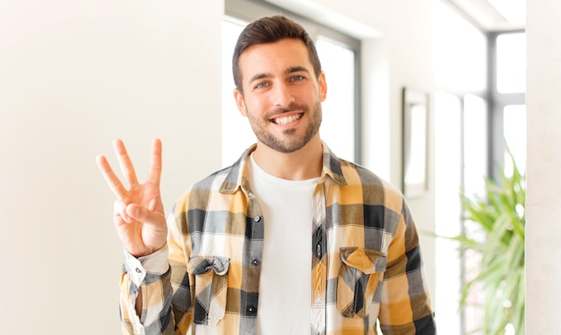 smiling and looking friendly, showing number three or third with hand forward, counting down